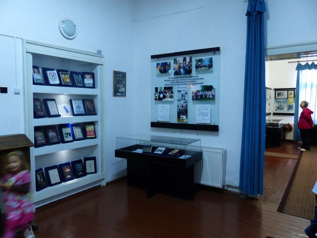 To the left, books written by Wiesel. Samples of his notes and book transcripts are in the glass case.