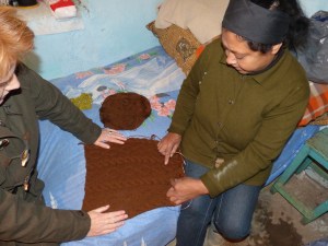Florina and Titina discuss a pattern during a recent visit to Titina's home. Florina visits the women frequently to encourage and pray with them.